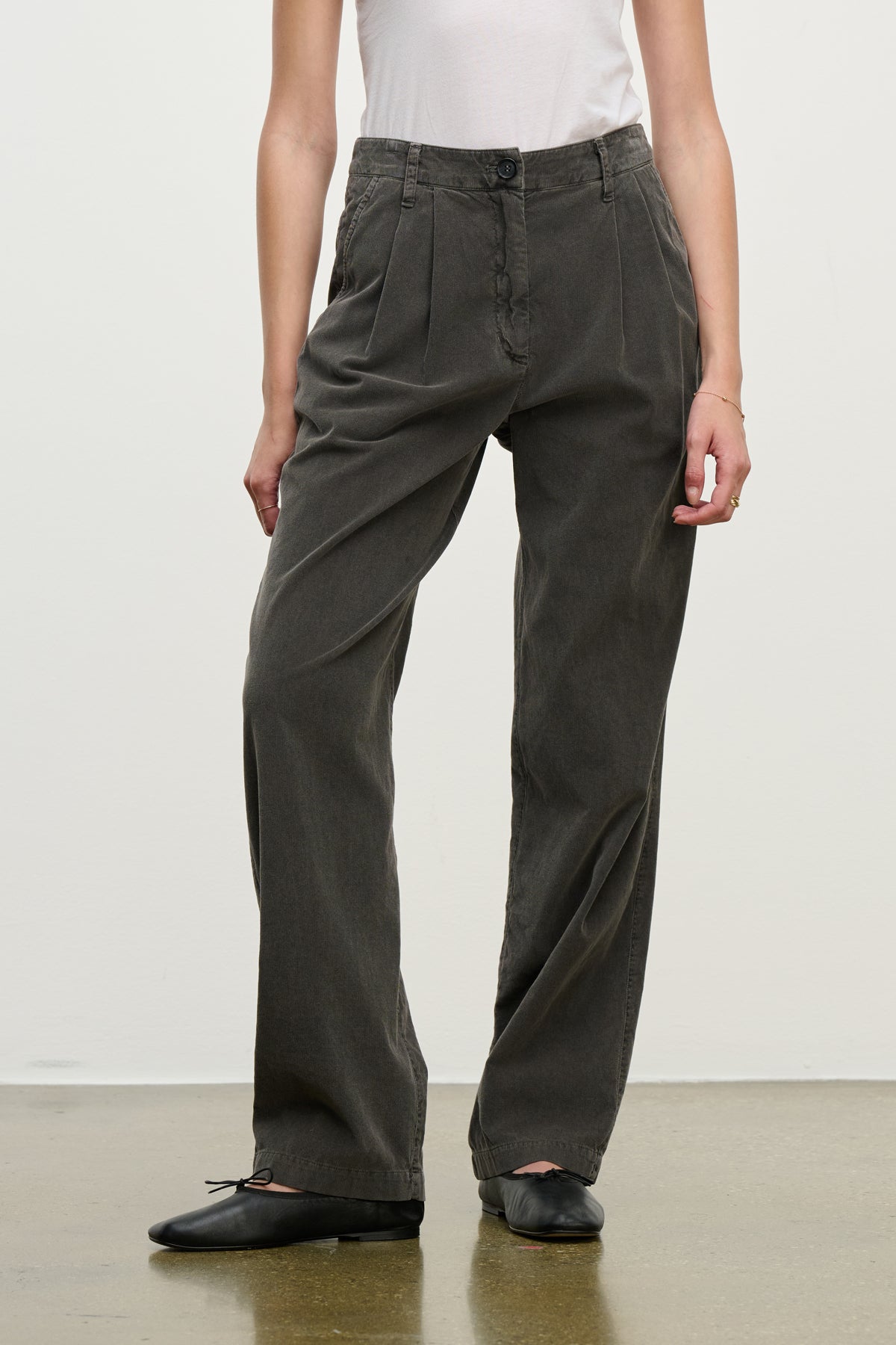 Model wears the GAIL CORDUROY PANT by Velvet by Graham & Spencer, paired with a white sleeveless top and black ballet flats, standing against a plain background.-39800318165185