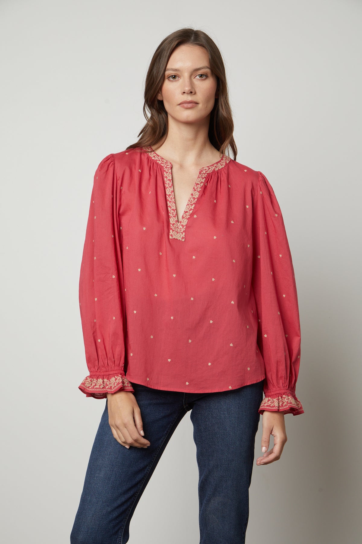 The model is wearing a red ANIA EMBROIDERED BOHO TOP from Velvet by Graham & Spencer, giving it a boho vibe.-35655725220033