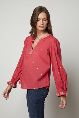 The model is wearing an ANIA EMBROIDERED BOHO TOP by Velvet by Graham & Spencer, giving it a boho vibe.