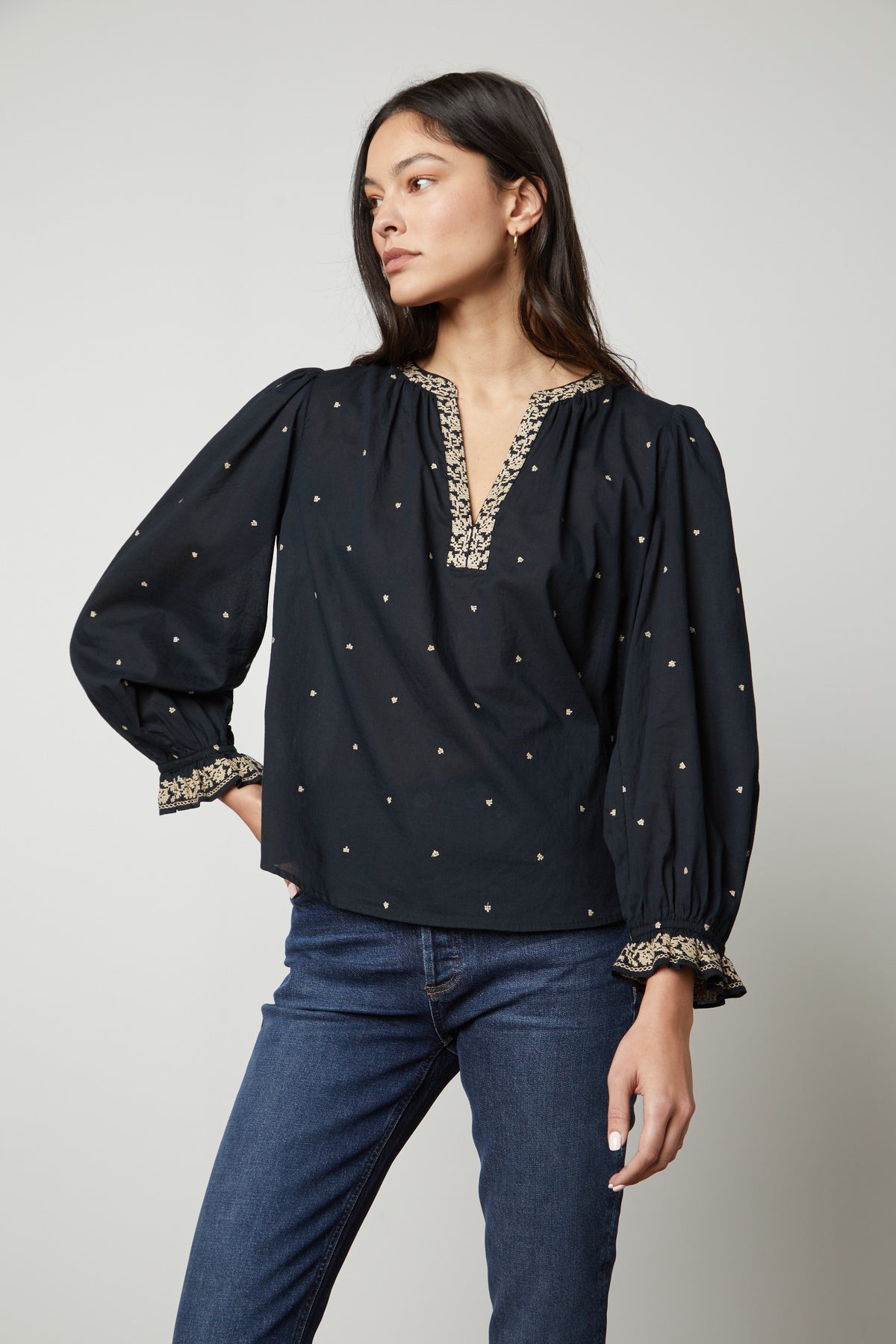   The model is wearing Velvet by Graham & Spencer ANIA EMBROIDERED BOHO TOP and jeans. 