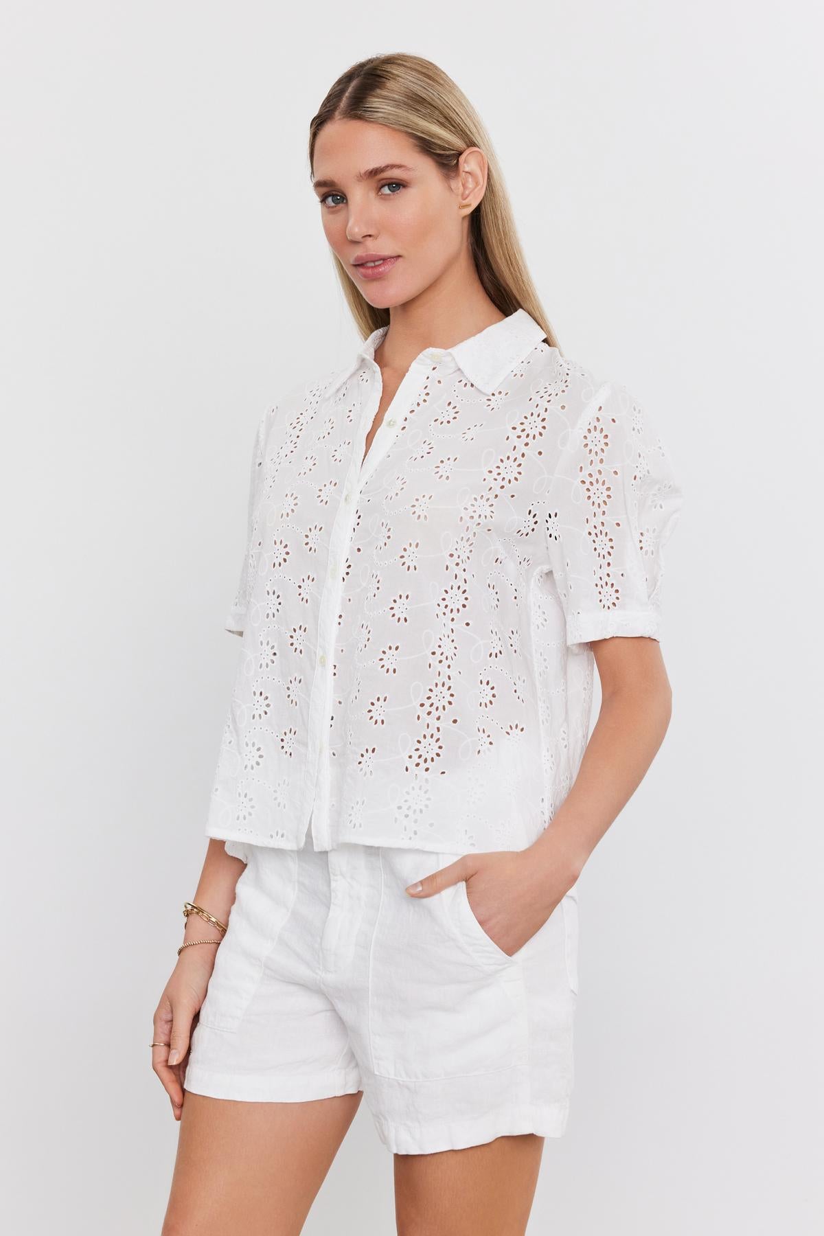 Woman in a white "OLIVIA BLOUSE" by Velvet by Graham & Spencer with detachable camisole and shorts posing against a plain background.-36918784884929