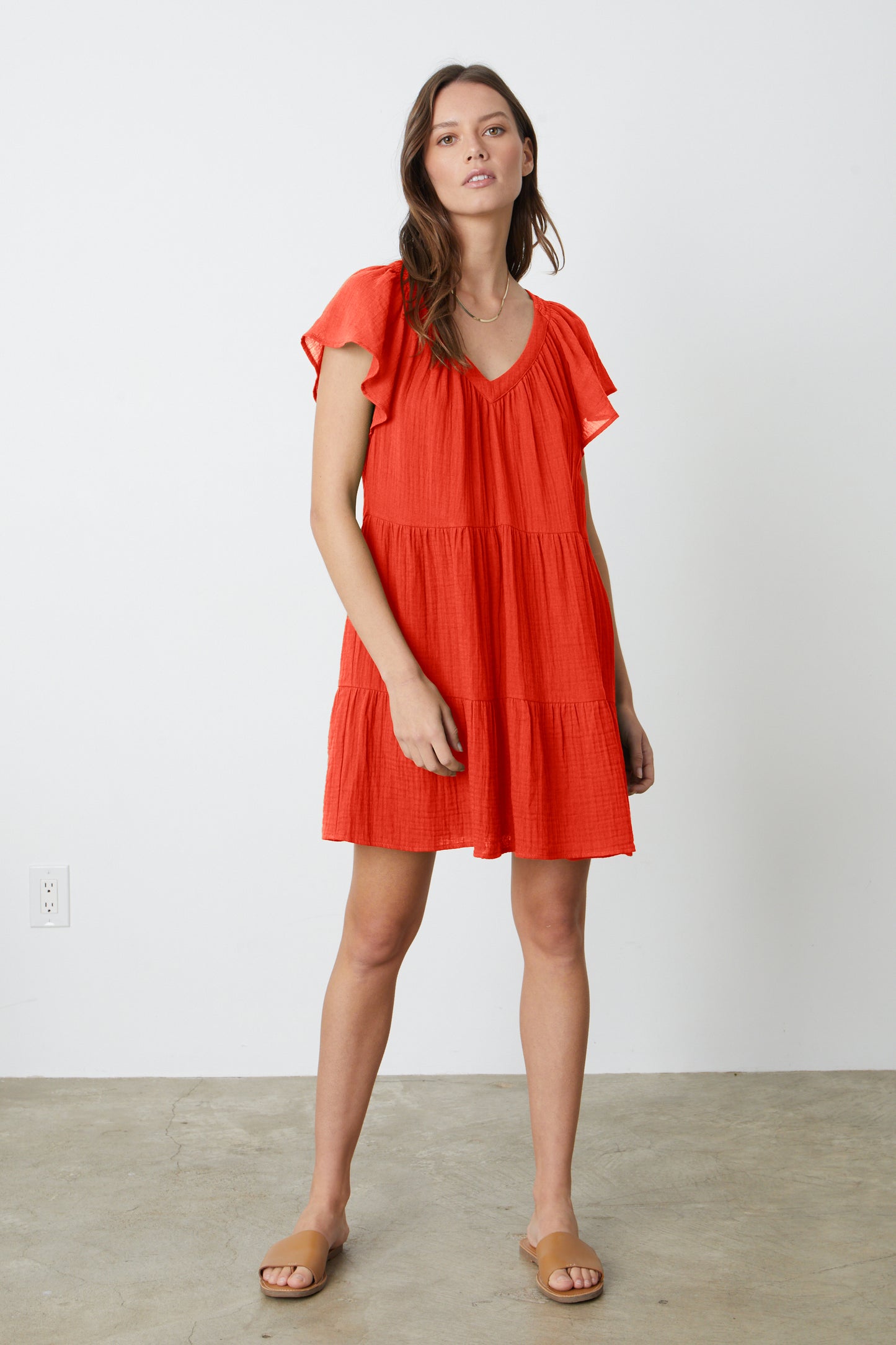 A woman wearing an ELEANOR COTTON GAUZE TIERED DRESS in cardinal red by Velvet by Graham & Spencer and sandals full length front.-26577372414145