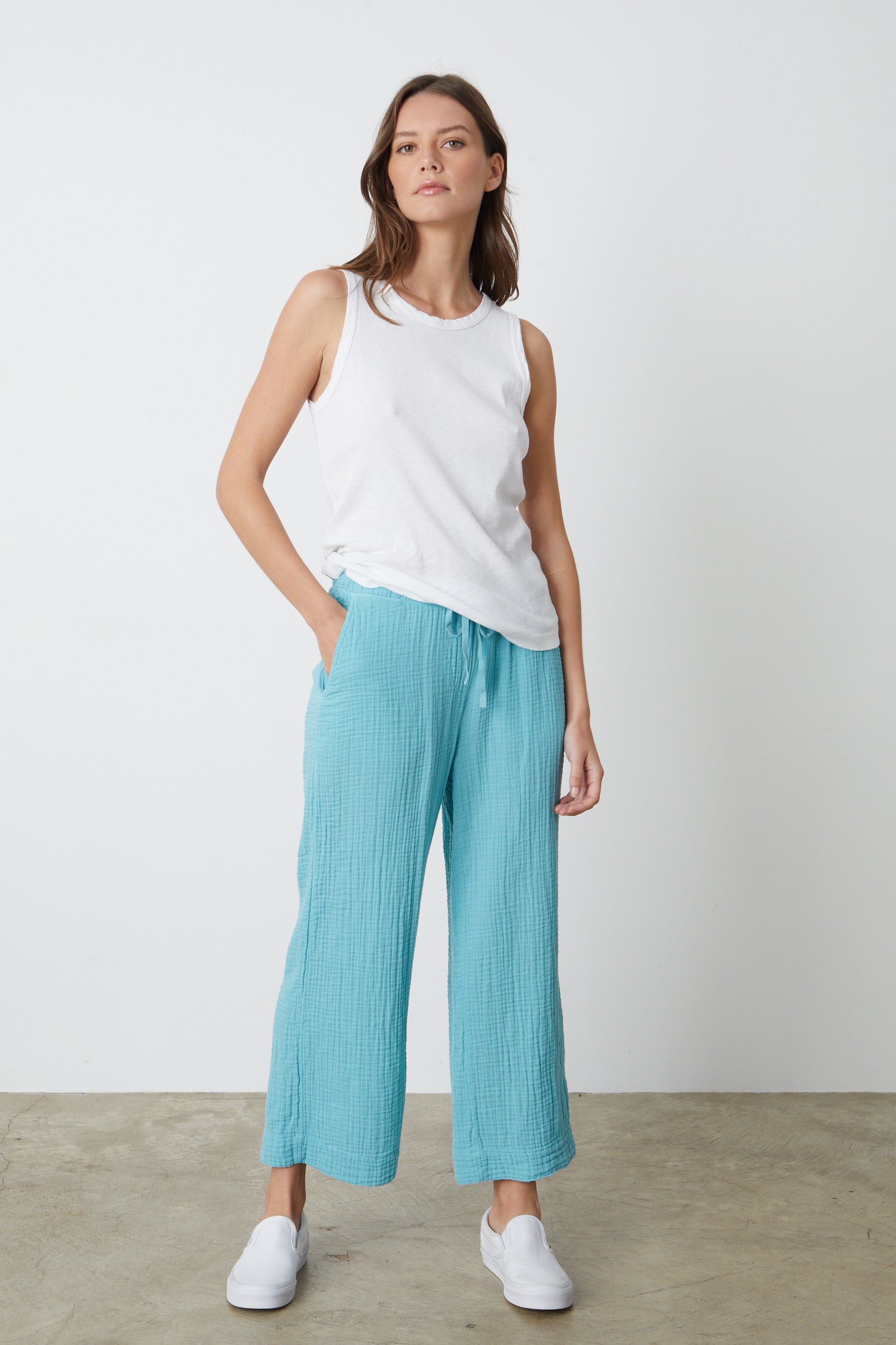   A model wearing a white tank top and Velvet by Graham & Spencer's FRANNY COTTON GAUZE PANT. 