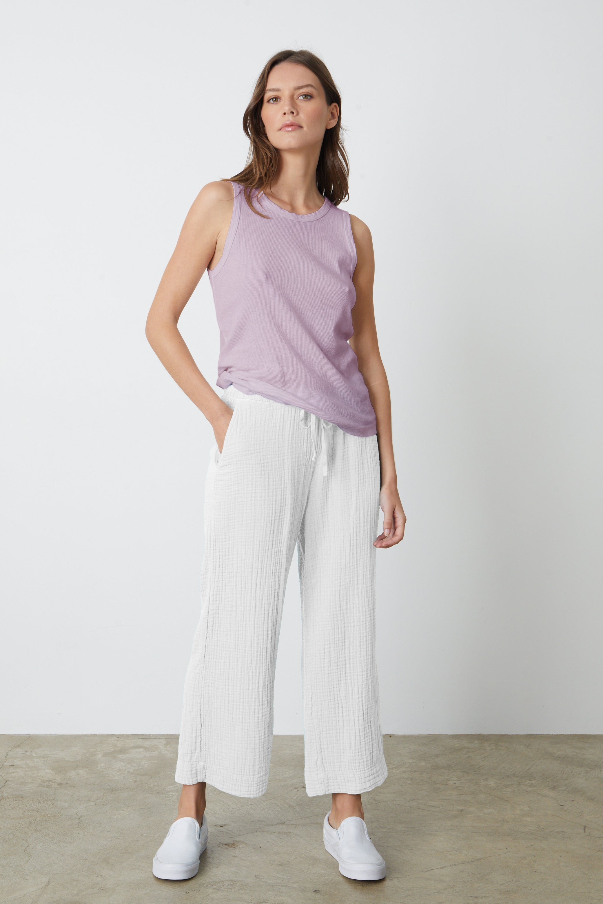   The model is wearing a white Velvet by Graham & Spencer FRANNY COTTON GAUZE PANT and lilac tank top. 