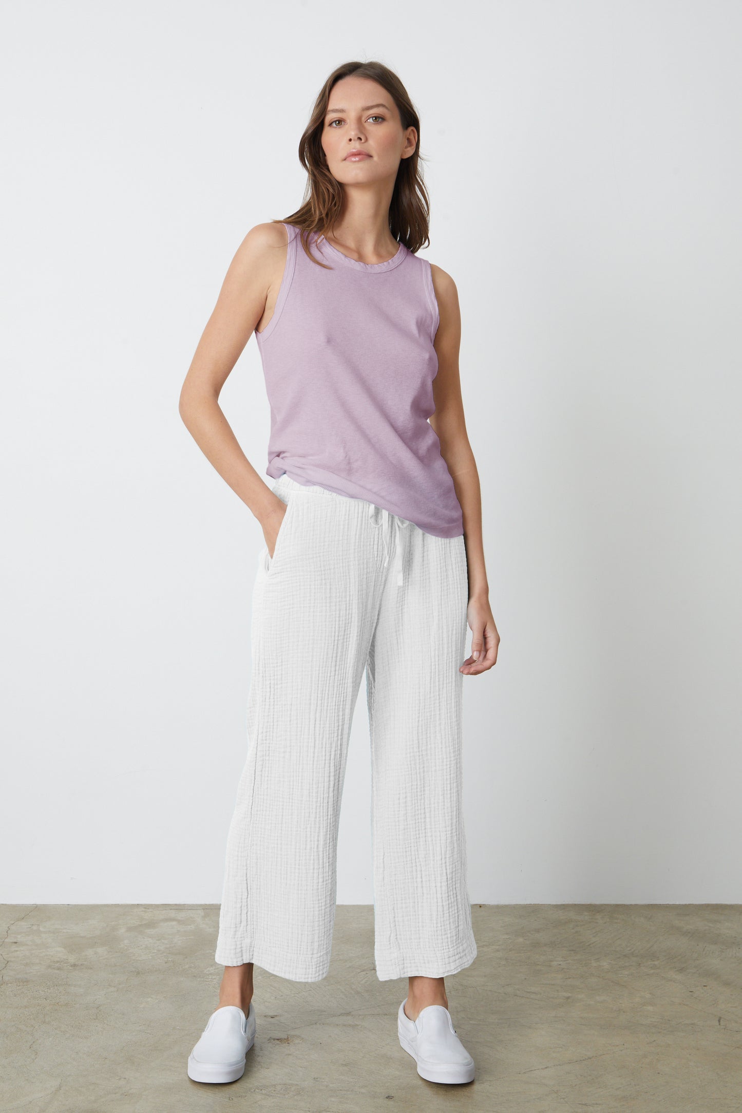 The model is wearing a white Velvet by Graham & Spencer FRANNY COTTON GAUZE PANT and lilac tank top.-26577359438017