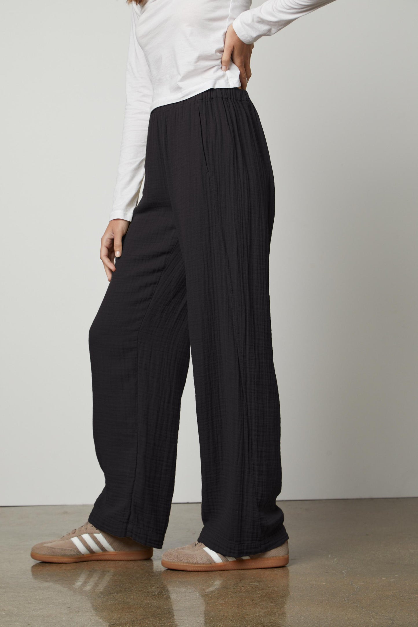 A woman wearing Velvet by Graham & Spencer's JERRY COTTON GAUZE PANT with an elastic waistband and a white t-shirt.-35660385059009