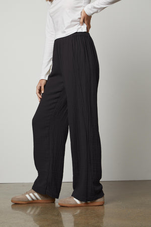 A woman wearing Velvet by Graham & Spencer's JERRY COTTON GAUZE PANT with an elastic waistband and a white t-shirt.