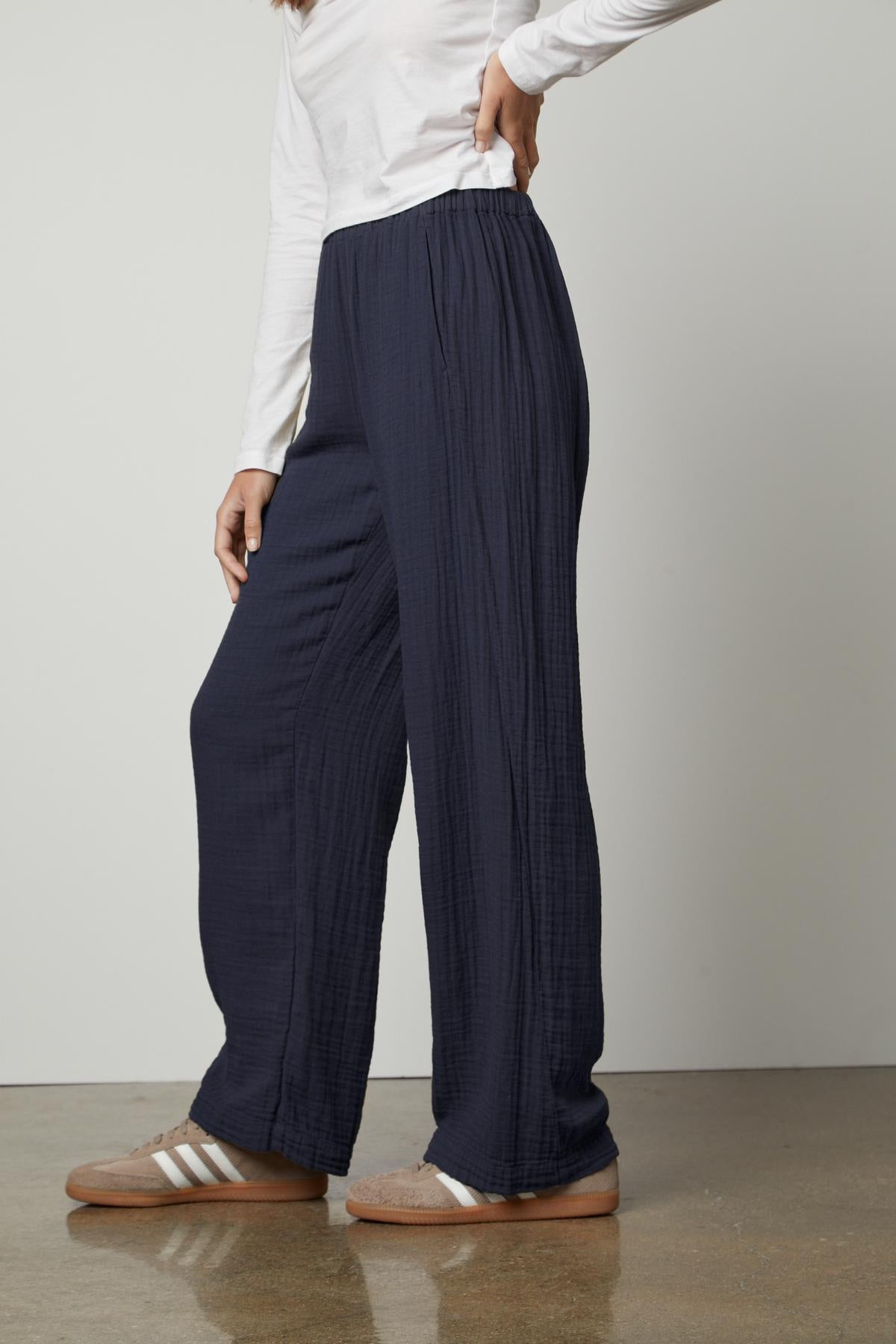   A woman wearing the Velvet by Graham & Spencer Jerry Cotton Gauze Pant with an elastic waistband and a white t-shirt. 