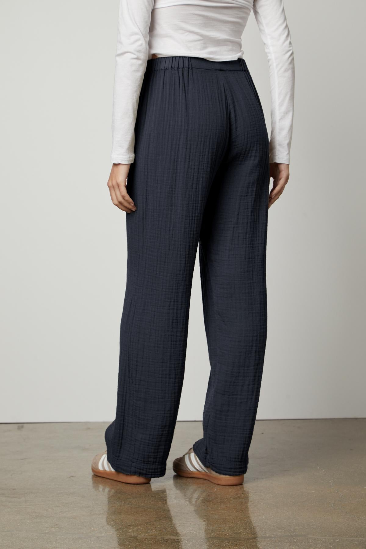 Woman wearing JERRY COTTON GAUZE PANT from Velvet by Graham & Spencer with an elastic waistband and white top against a neutral background.-36462913650881
