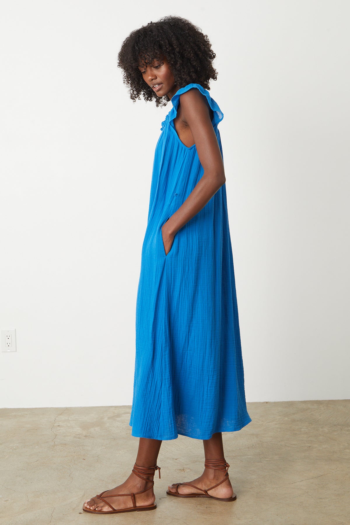 A woman wearing a Velvet by Graham & Spencer blue Justine Cotton Gauze Midi Dress and sandals.-26342712934593
