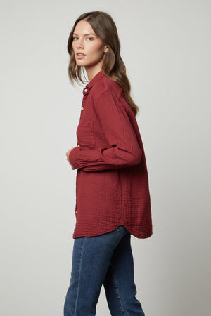 The model is wearing an oversized MARGO COTTON GAUZE BUTTON-UP SHIRT by Velvet by Graham & Spencer.