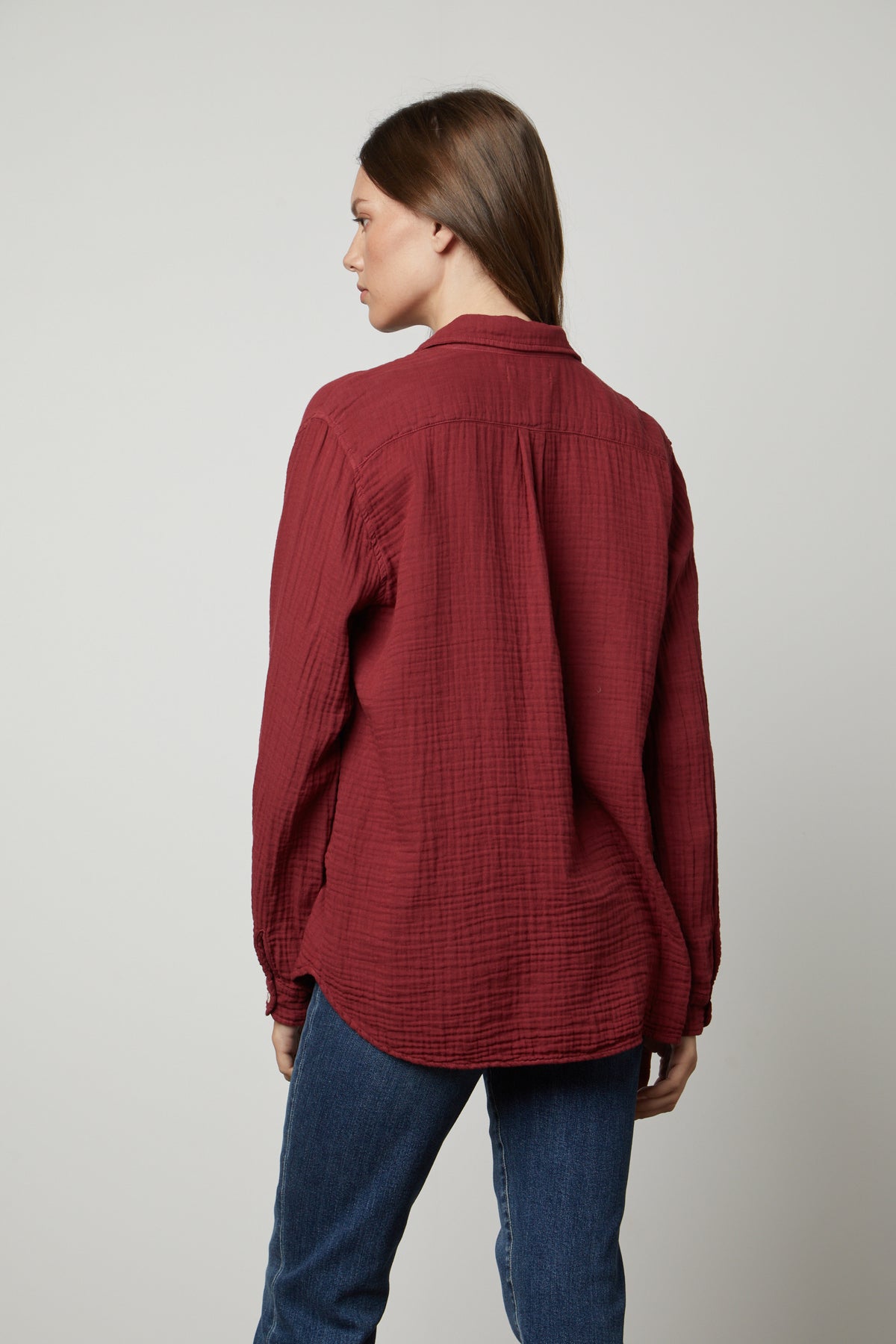 The back view of a woman wearing an oversized fit MARGO COTTON GAUZE BUTTON-UP SHIRT, made by Velvet by Graham & Spencer, and jeans.-35655728398529