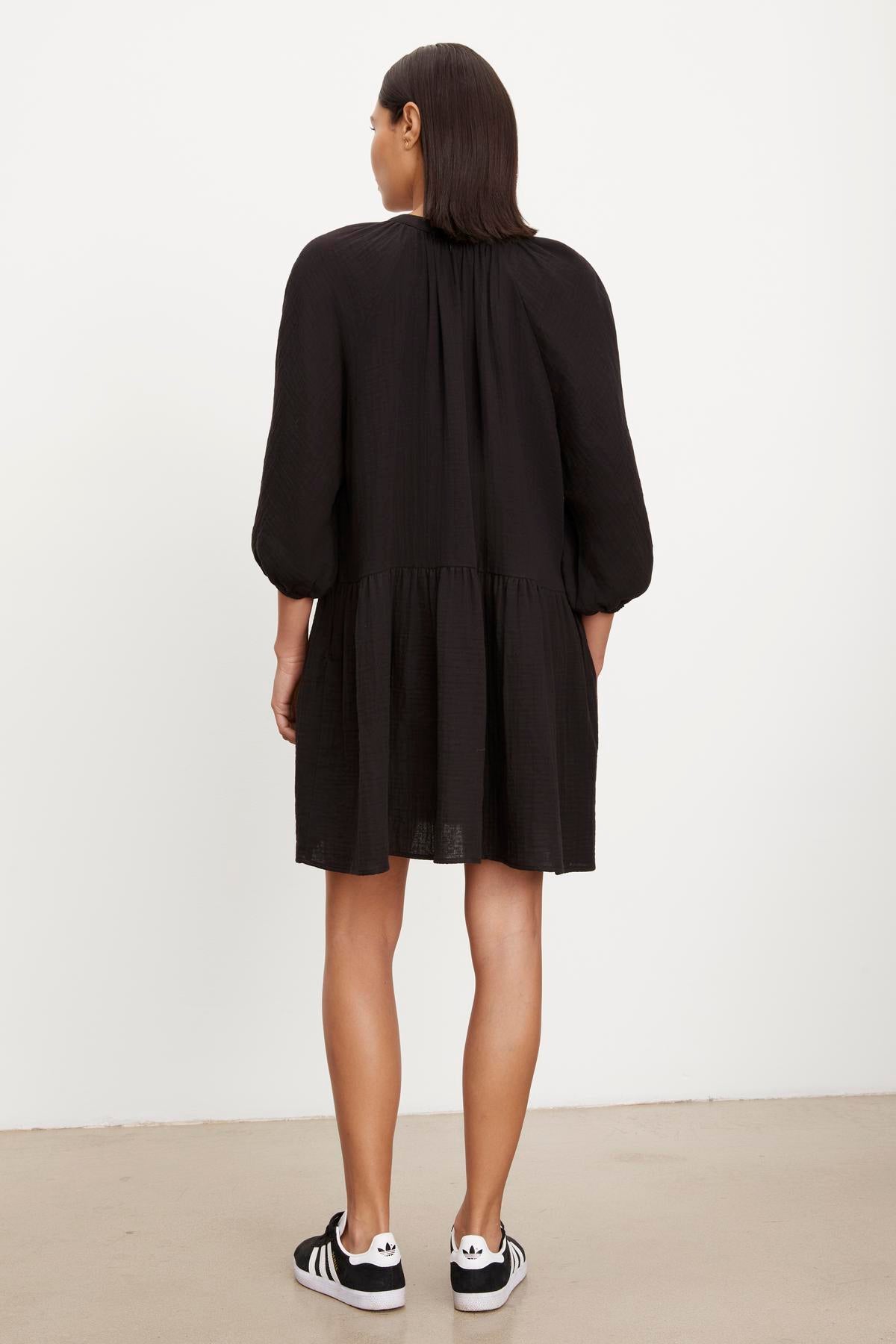   The back view of a woman wearing a Velvet by Graham & Spencer NICA COTTON GAUZE DRESS. 