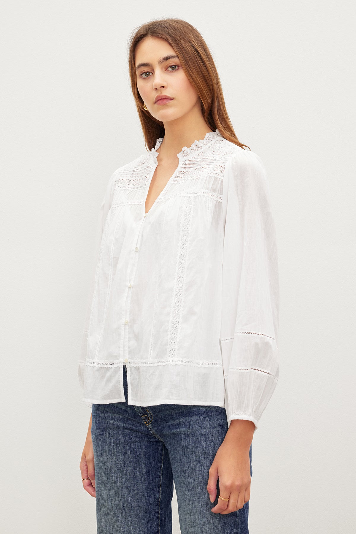   A woman in a white Velvet by Graham & Spencer LIAM COTTON LACE BUTTON FRONT TOP shirt. 