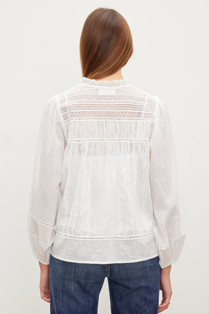 The back view of a woman wearing a Velvet by Graham & Spencer LIAM COTTON LACE BUTTON FRONT TOP.