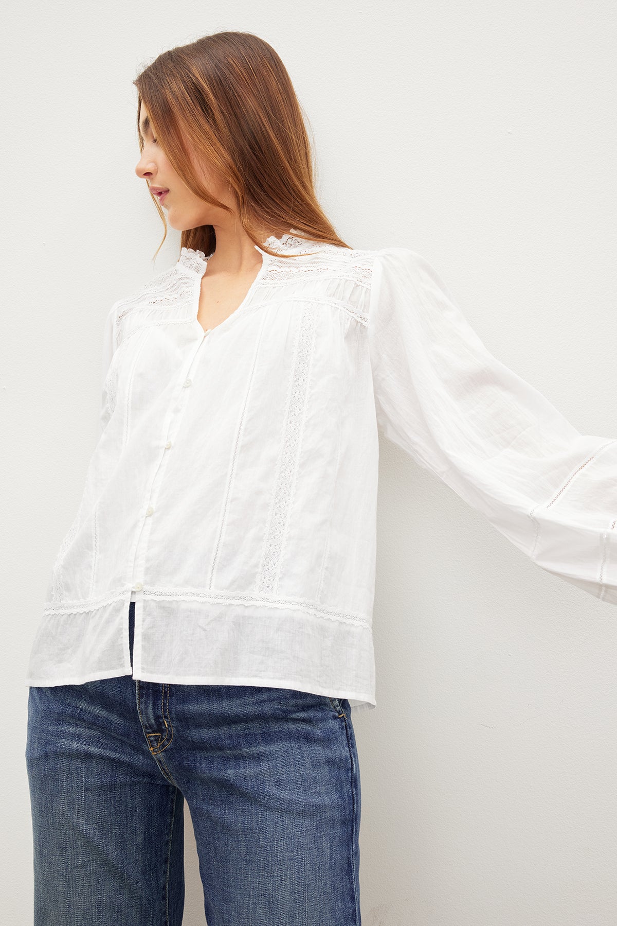   A woman in a LIAM COTTON LACE BUTTON FRONT TOP by Velvet by Graham & Spencer. 