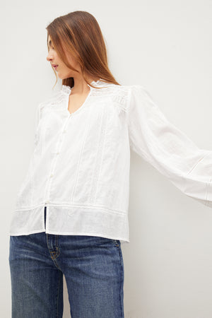 A woman in a LIAM COTTON LACE BUTTON FRONT TOP by Velvet by Graham & Spencer.