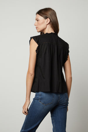 The back view of a woman wearing a Velvet by Graham & Spencer LIANA LACE TANK TOP and jeans.