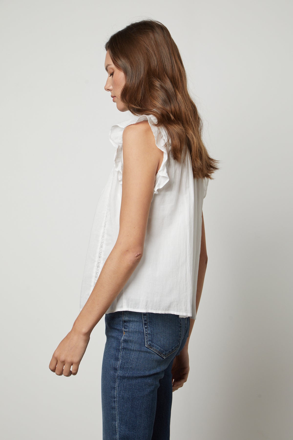   The back view of a woman wearing jeans and the LIANA LACE TANK TOP by Velvet by Graham & Spencer. 
