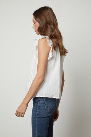 The back view of a woman wearing jeans and the LIANA LACE TANK TOP by Velvet by Graham & Spencer.