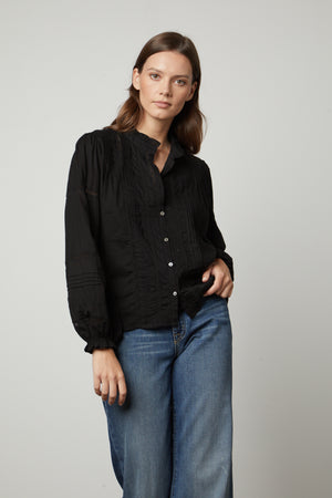 The model is wearing a ROMY LACE BOHO TOP blouse and jeans. (Brand: Velvet by Graham & Spencer)