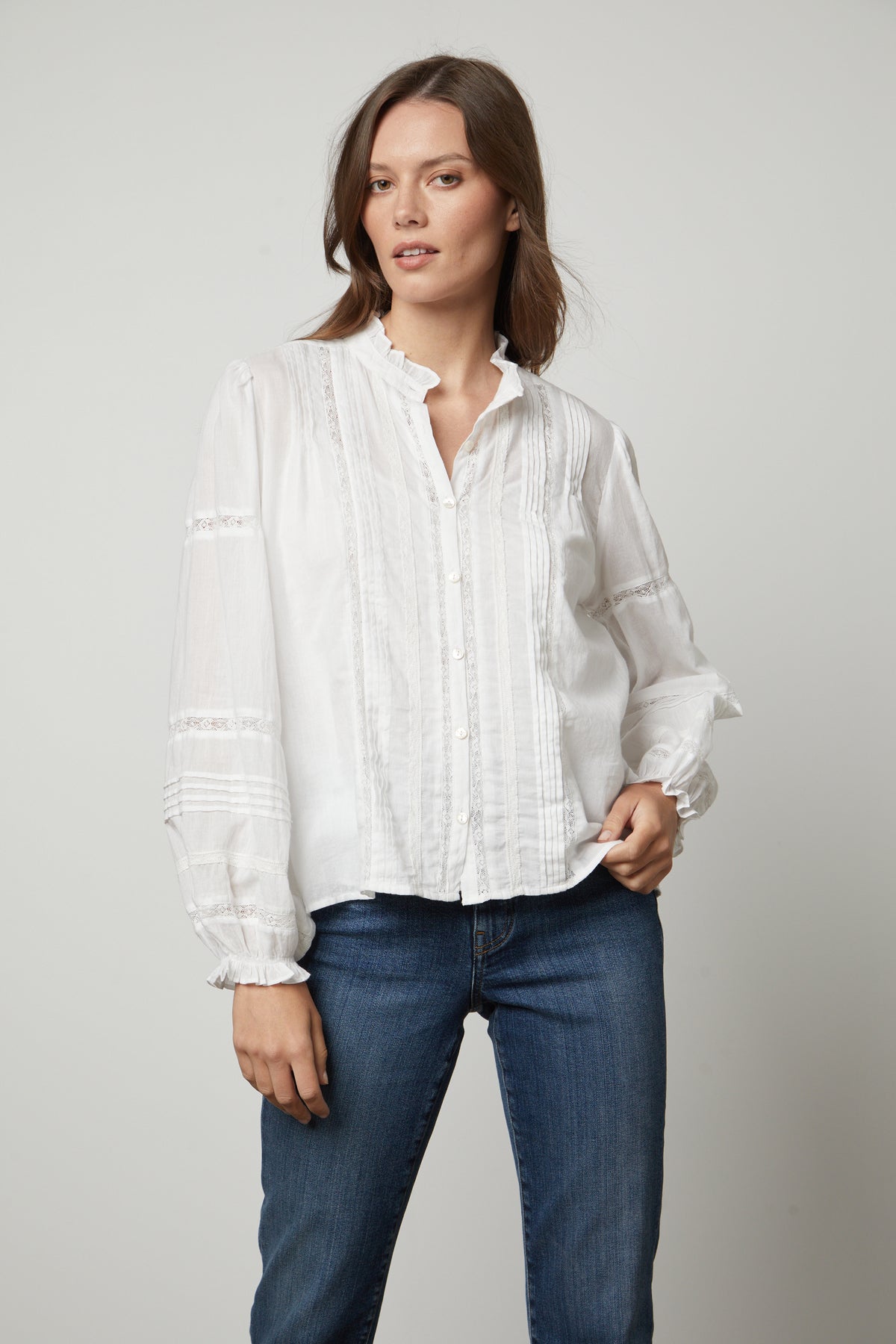 The model is wearing Velvet by Graham & Spencer jeans and a Velvet by Graham & Spencer white blouse.-26834995478721
