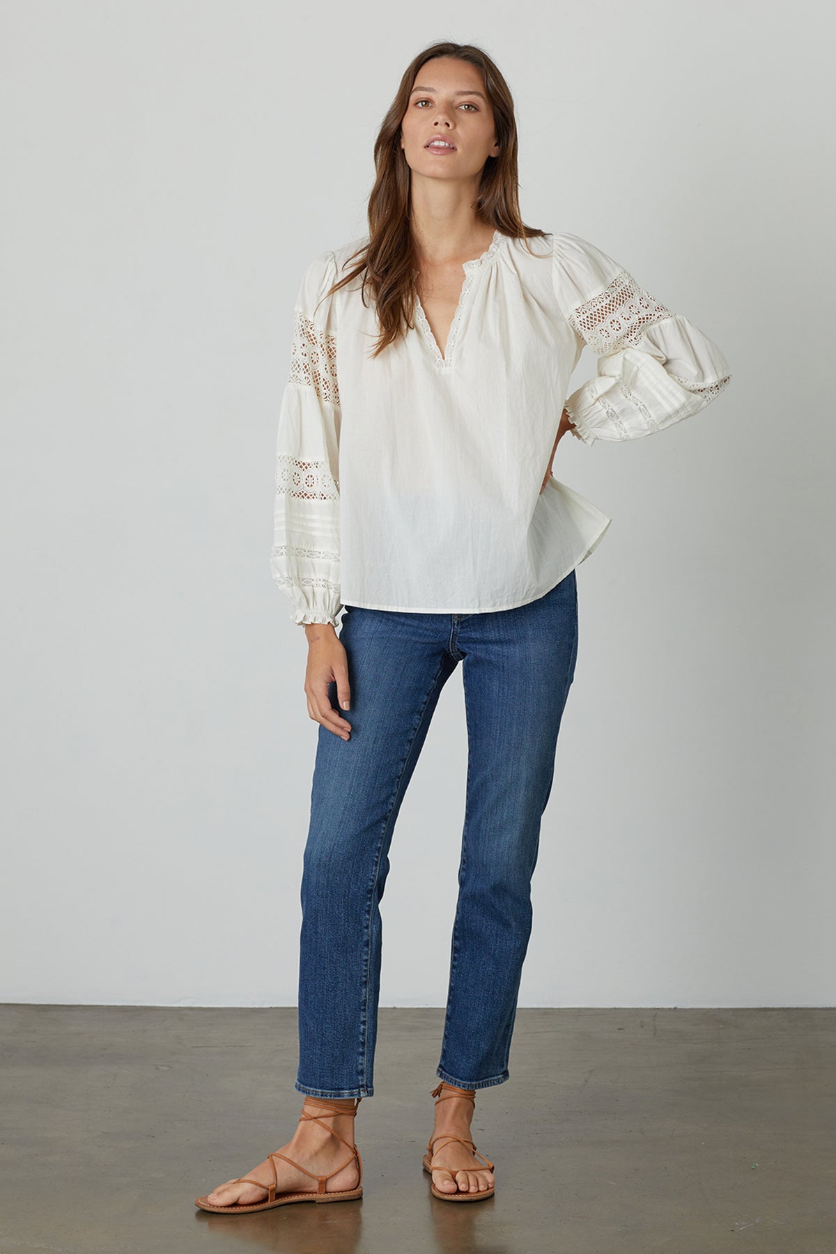   The model is wearing Velvet by Graham & Spencer jeans and a TAYLER COTTON LACE BOHO TOP. 