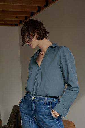 A woman wearing blue jeans and a BREA SHIRT by Velvet by Jenny Graham.