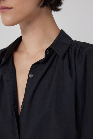 The model is wearing a black cotton Palisades shirt by Velvet by Jenny Graham.