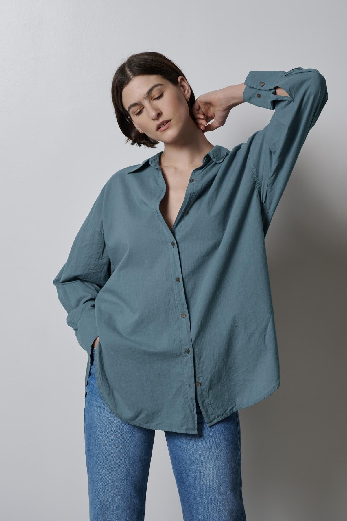 The model is wearing a Redondo button-up shirt by Velvet by Jenny Graham and jeans.-35783065927873