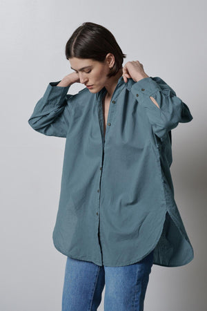 The model is wearing an oversized REDONDO BUTTON-UP SHIRT by Velvet by Jenny Graham.