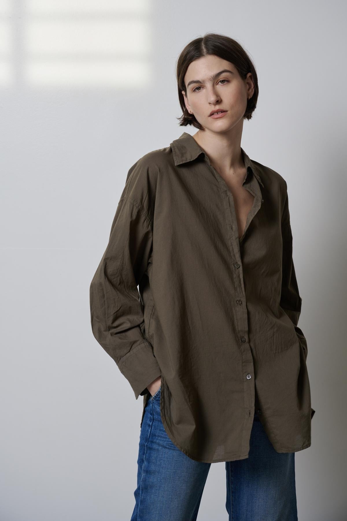 The model is wearing an oversized Velvet by Jenny Graham REDONDO BUTTON-UP SHIRT and jeans.-35783065665729