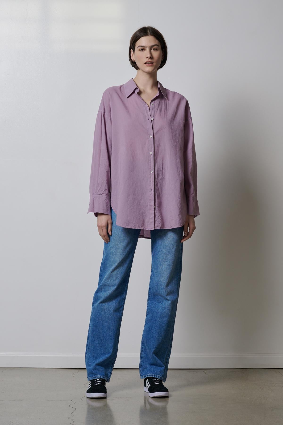  The model is wearing a Velvet by Jenny Graham REDONDO BUTTON-UP SHIRT and blue jeans. 