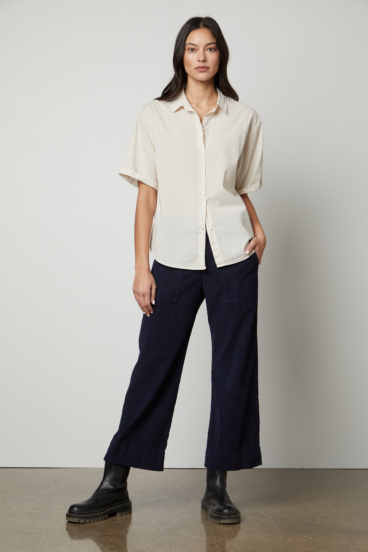 The model is wearing a Shannon Button-Up Shirt by Velvet by Graham & Spencer and navy trousers.-26799857959105