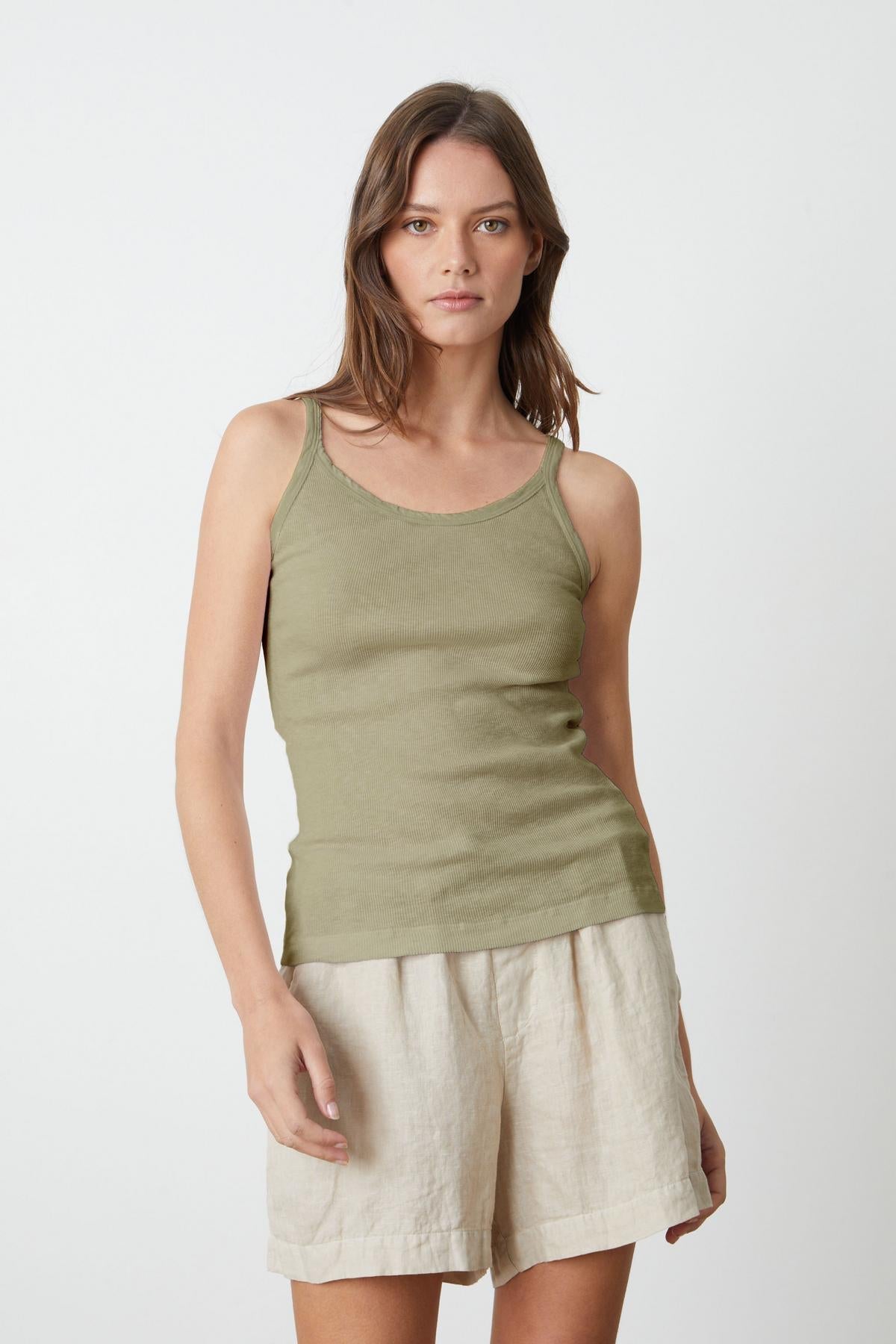 a woman wearing a Velvet by Graham & Spencer ALIZA RIBBED COTTON LAYERING TANK and beige shorts.-35206750011585