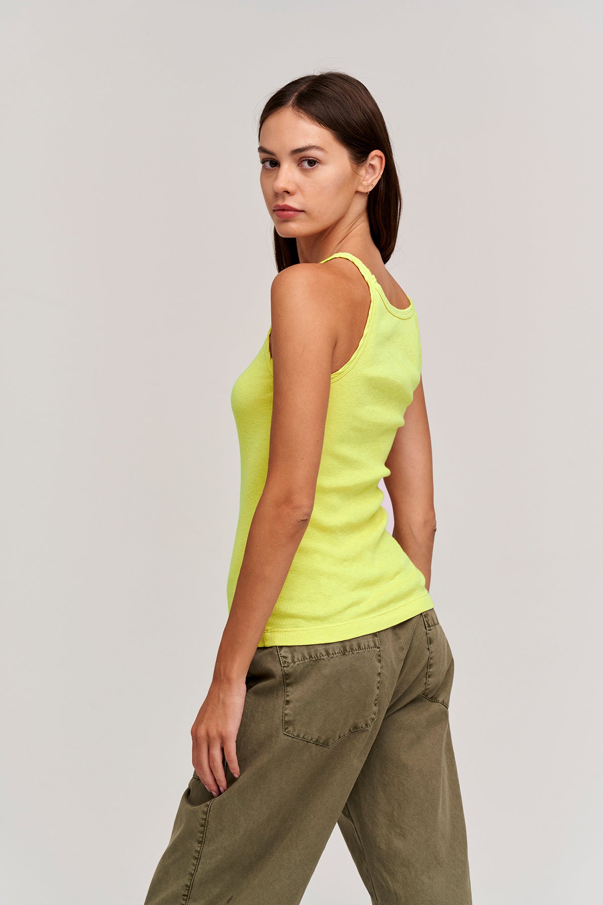 a woman wearing a Velvet by Graham & Spencer ALIZA RIBBED COTTON LAYERING TANK and green pants.-26629408063681