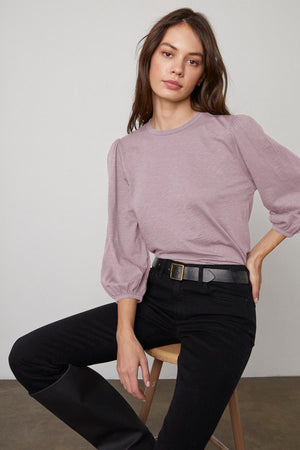The model is wearing an ANETTE PUFF SLEEVE TEE in cotton slub knit from Velvet by Graham & Spencer.