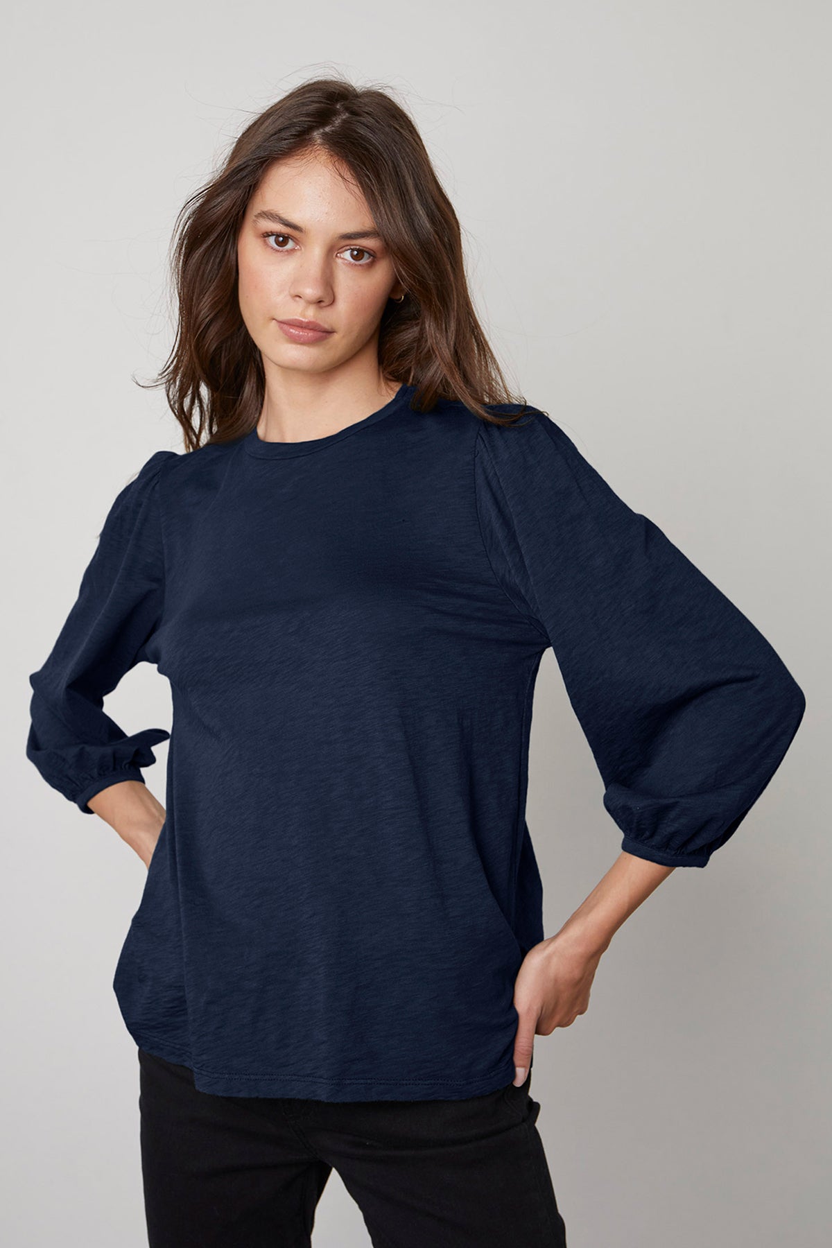 The model is wearing a navy ANETTE PUFF SLEEVE TEE by Velvet by Graham & Spencer.-26799865790657
