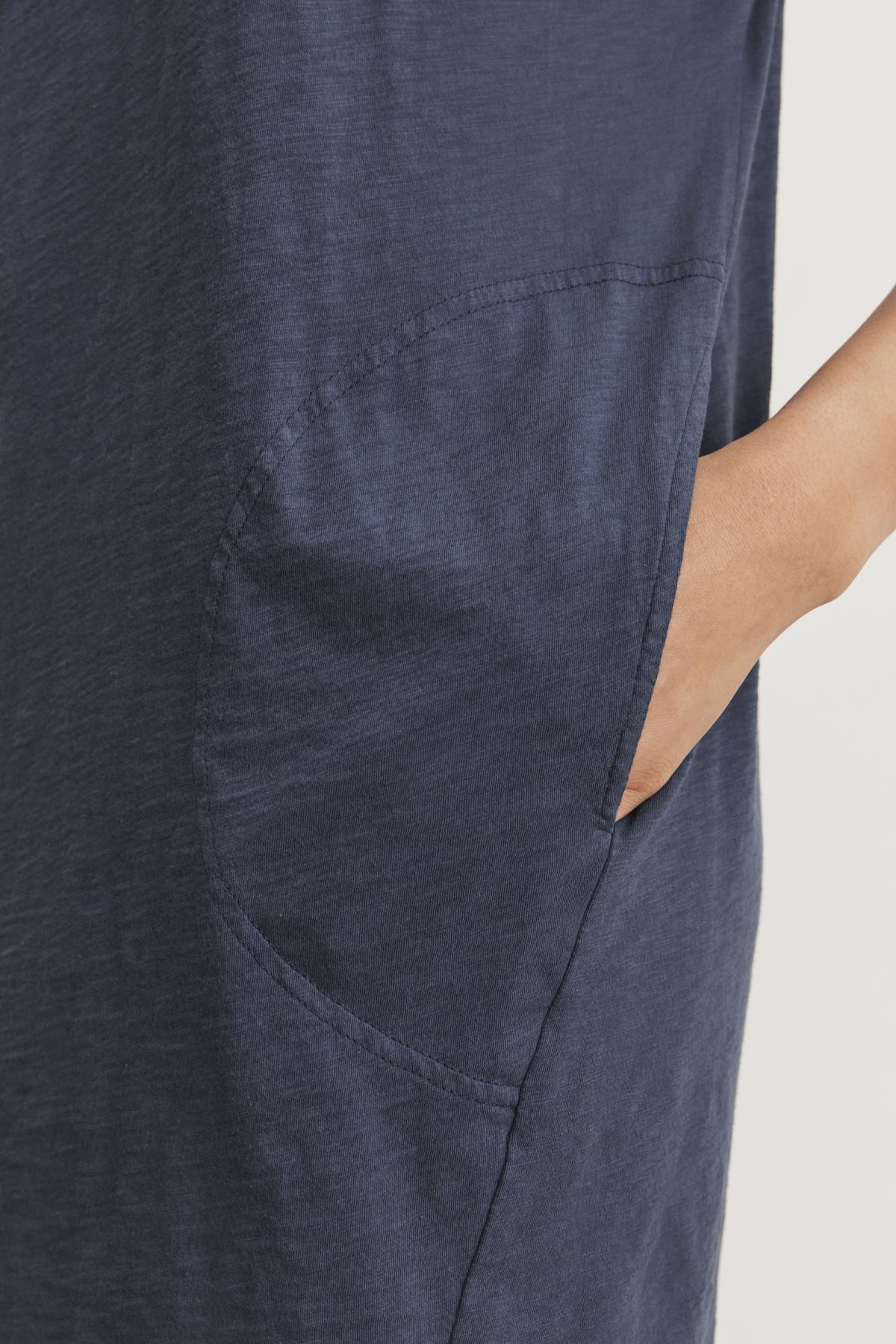 Close-up of a person’s hand resting in the pocket of an ATHENA DRESS by Velvet by Graham & Spencer, highlighting the relaxed fit and soft cotton slub fabric.-37606520324289