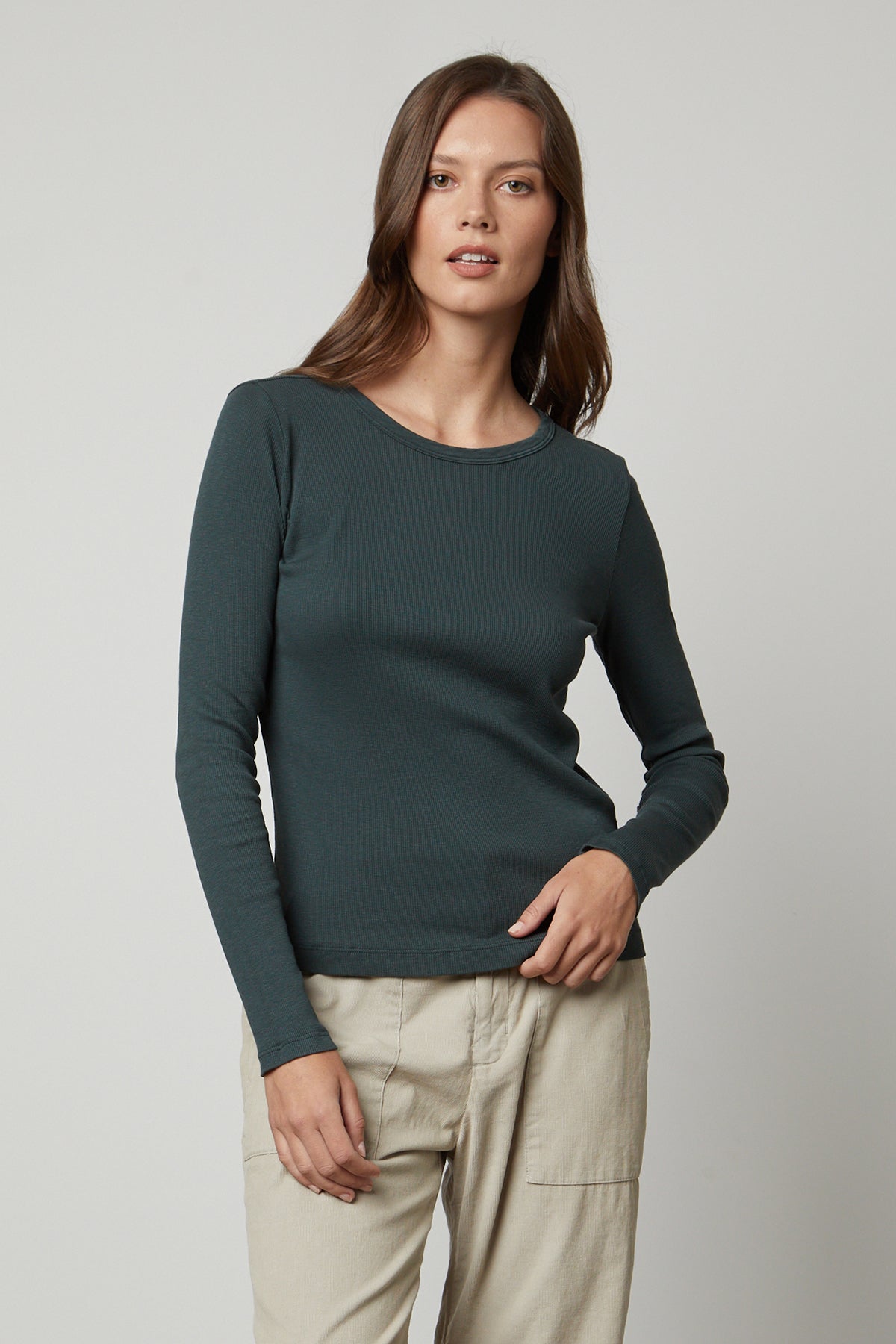   A woman wearing the Velvet by Graham & Spencer BAYLER RIBBED SCOOP NECK TEE and khaki pants. 