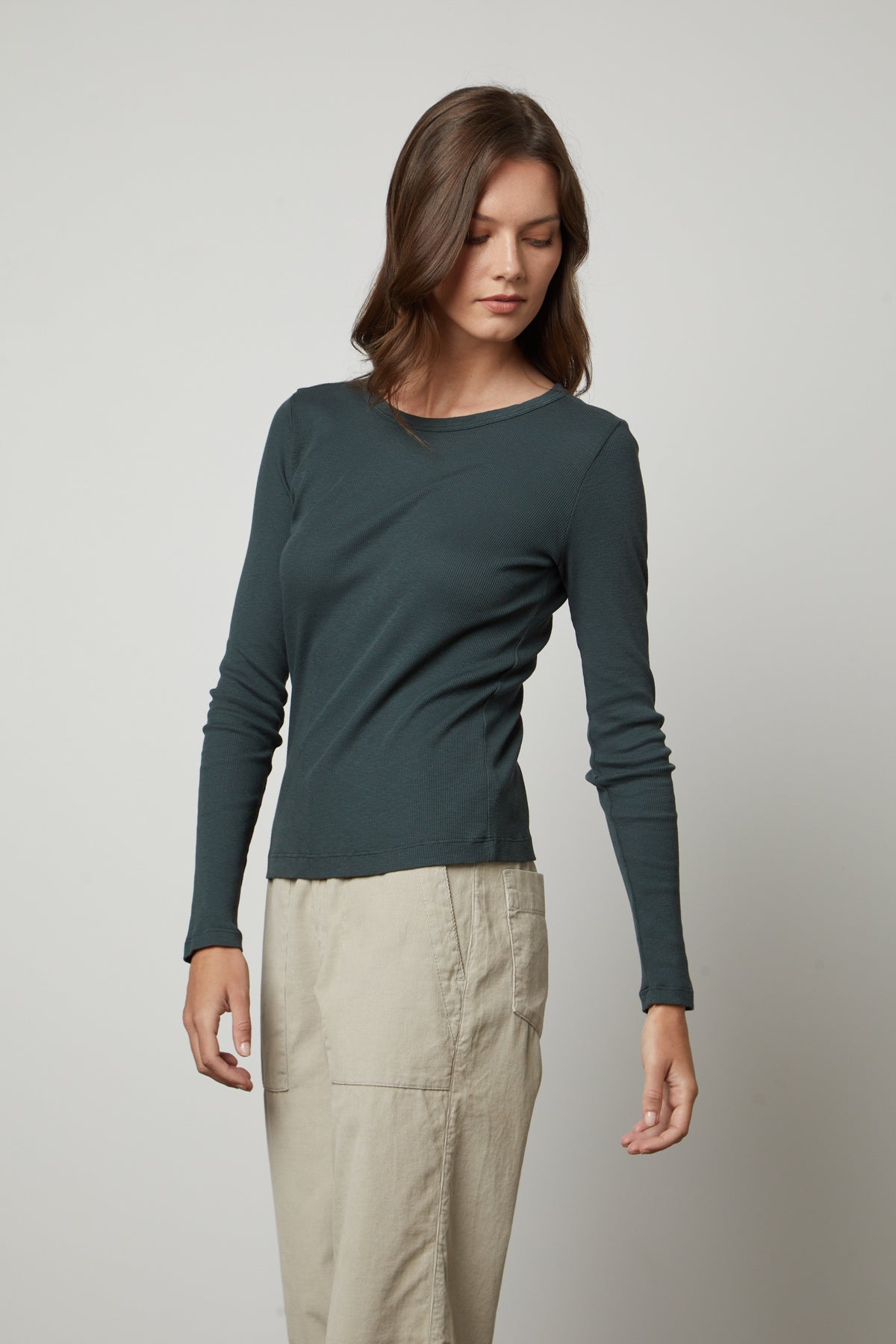   The model is wearing a Velvet by Graham & Spencer BAYLER RIBBED SCOOP NECK TEE and khaki pants. 