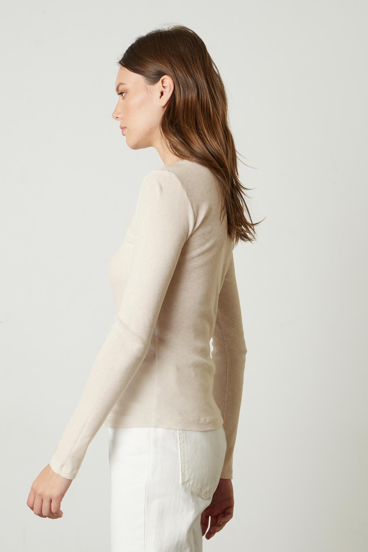   The back view of a woman wearing a Velvet by Graham & Spencer BAYLER RIBBED SCOOP NECK TEE. 