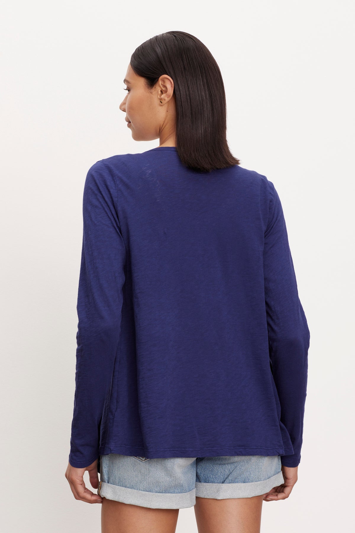 The back view of a woman wearing a Velvet by Graham & Spencer CHAMPAGNE OPEN CARDIGAN.-26743571841217