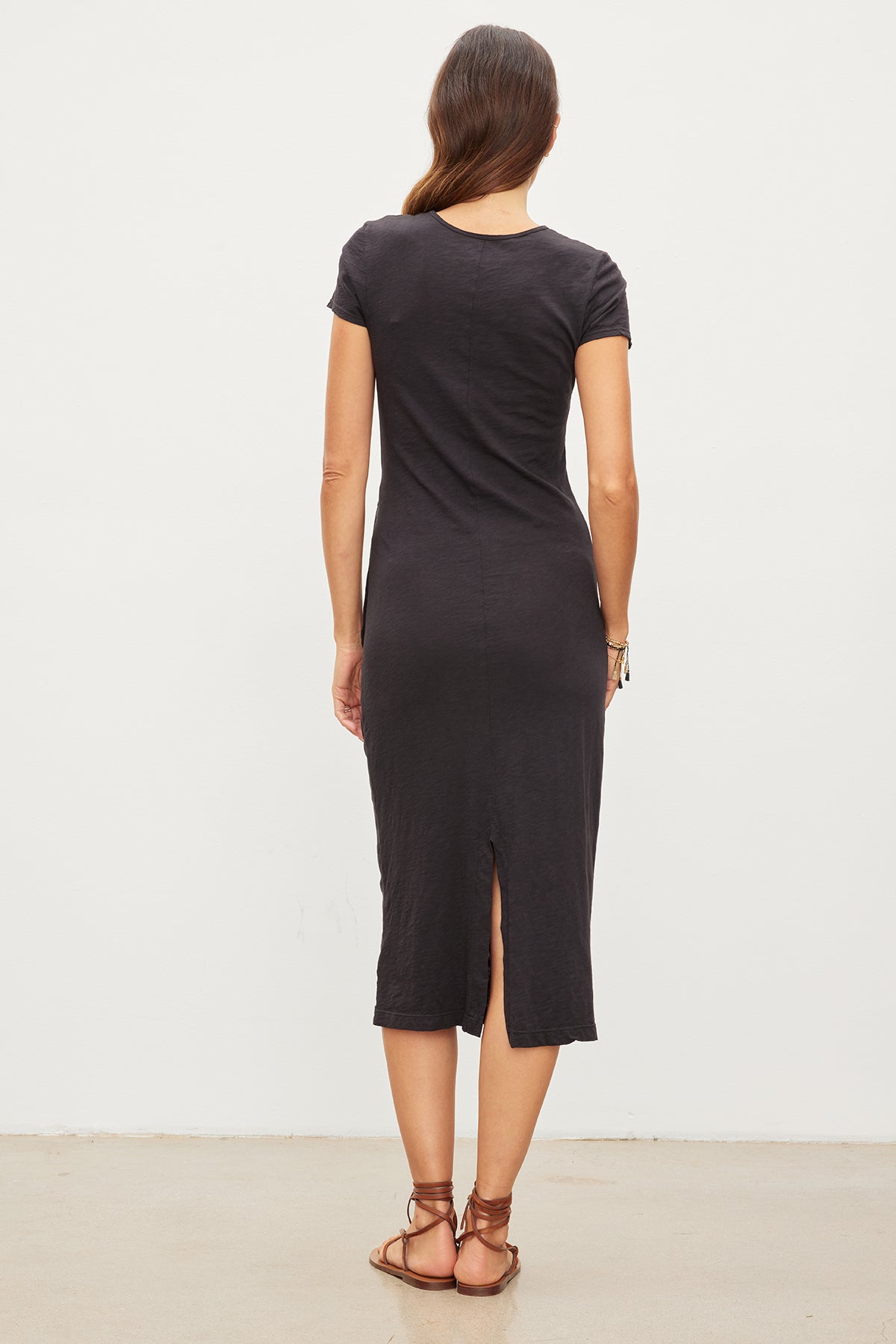 The back view of a woman wearing a Velvet by Graham & Spencer Darcy Cotton Slub Midi Dress.-35955695878337