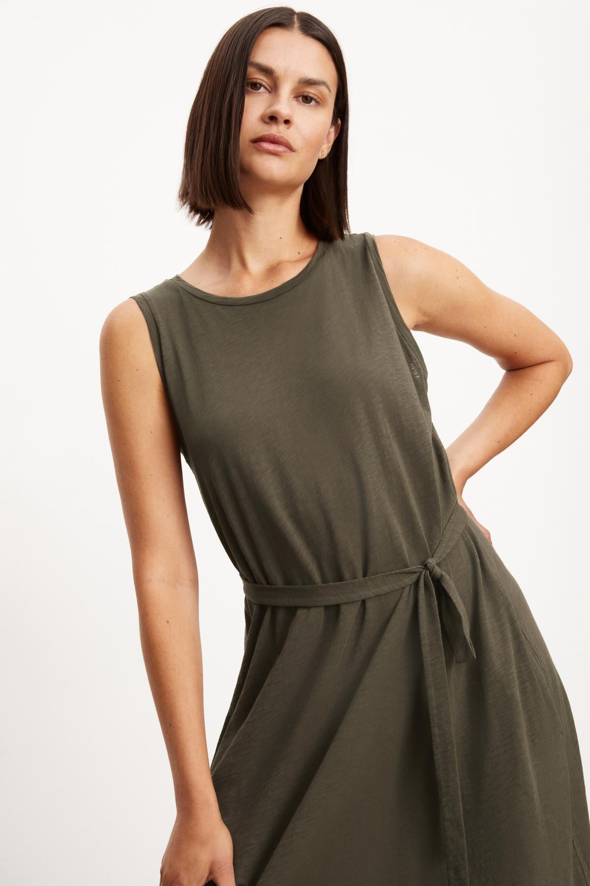 The EDITH SLEEVELESS MAXI DRESS by Velvet by Graham & Spencer in olive green features a long silhouette and slash pockets.-35701765865665