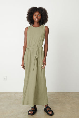 a woman wearing the Velvet by Graham & Spencer EDITH SLEEVELESS MAXI DRESS in sage green.