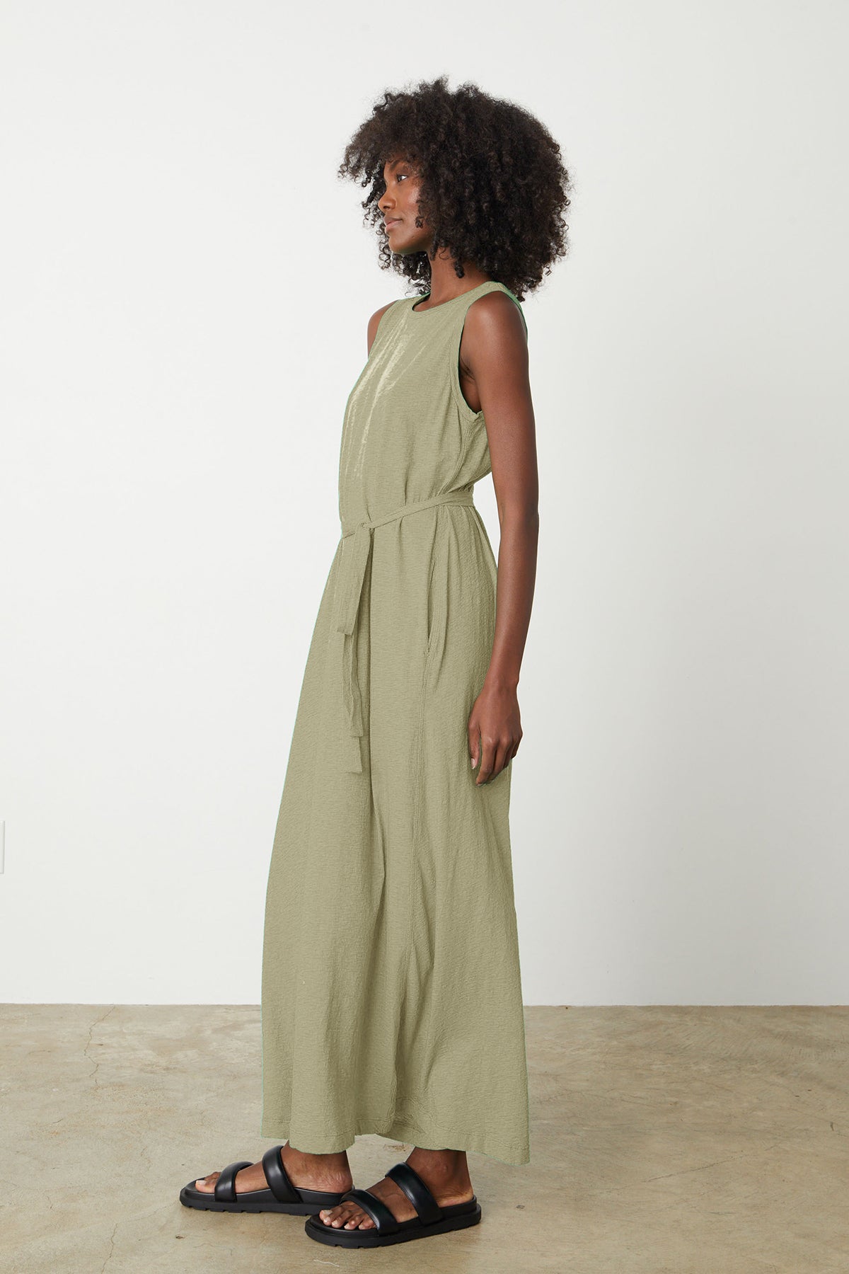   a woman wearing the EDITH SLEEVELESS MAXI DRESS by Velvet by Graham & Spencer. 