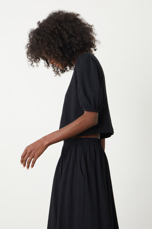The model is wearing a HILARY PUFF SLEEVE CROPPED TEE by Velvet by Graham & Spencer.