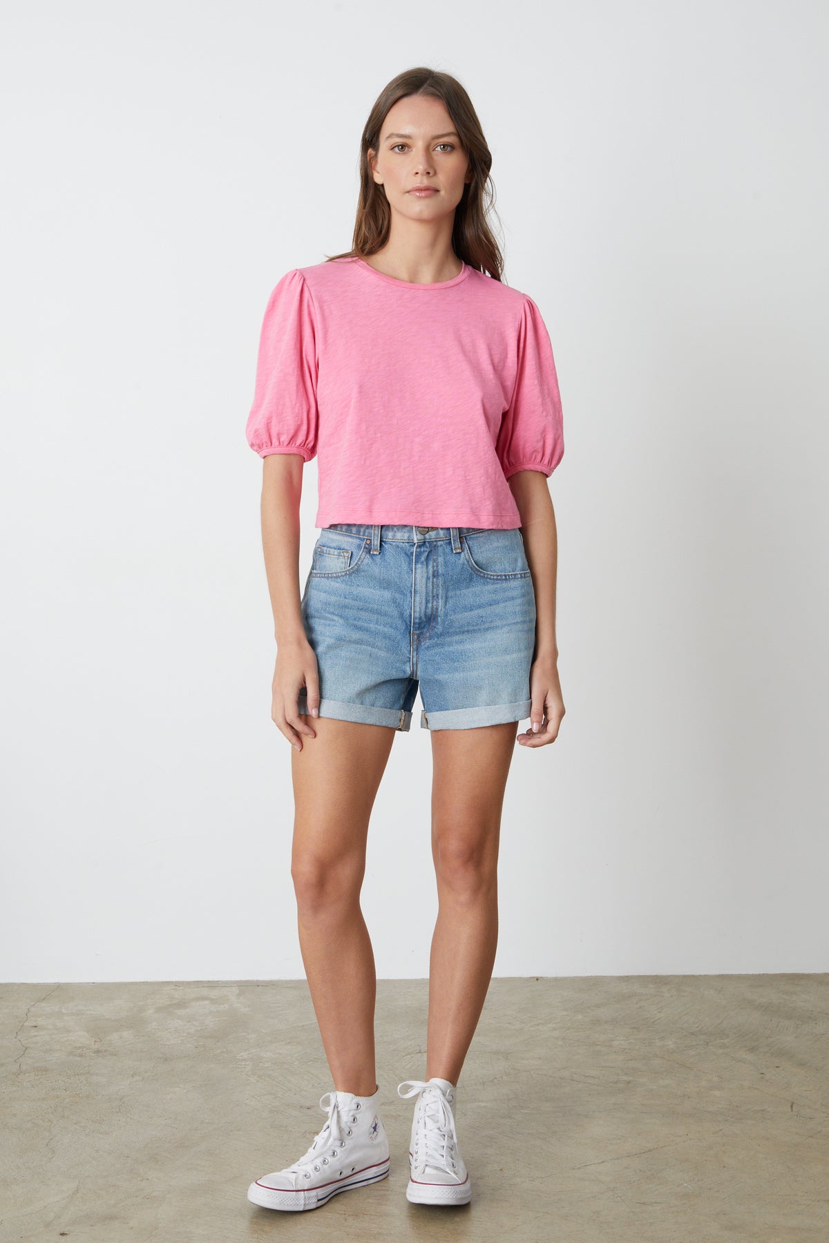   a model wearing a Velvet by Graham & Spencer HILARY PUFF SLEEVE CROPPED TEE and denim shorts. 