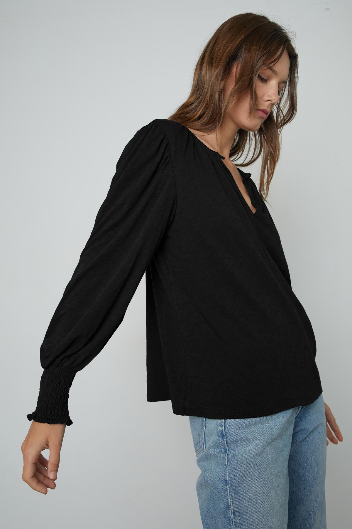 The IRINA SPLIT NECK TEE by Velvet by Graham & Spencer is worn by a woman.-26883564896449